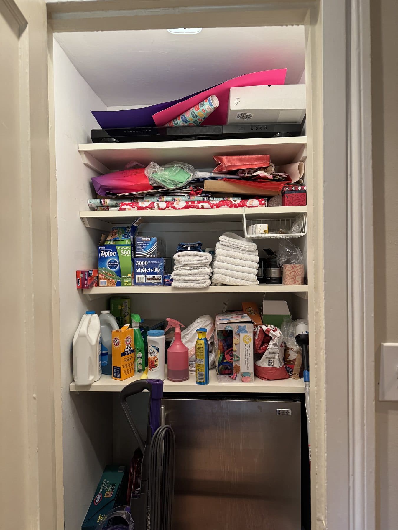 Overfilled pantry shelves before decluttering and organization